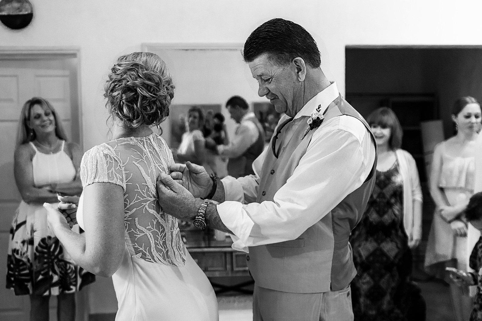 Father of the bride checking the bride's dress at the bridal suite of the Martoca Beach Garden