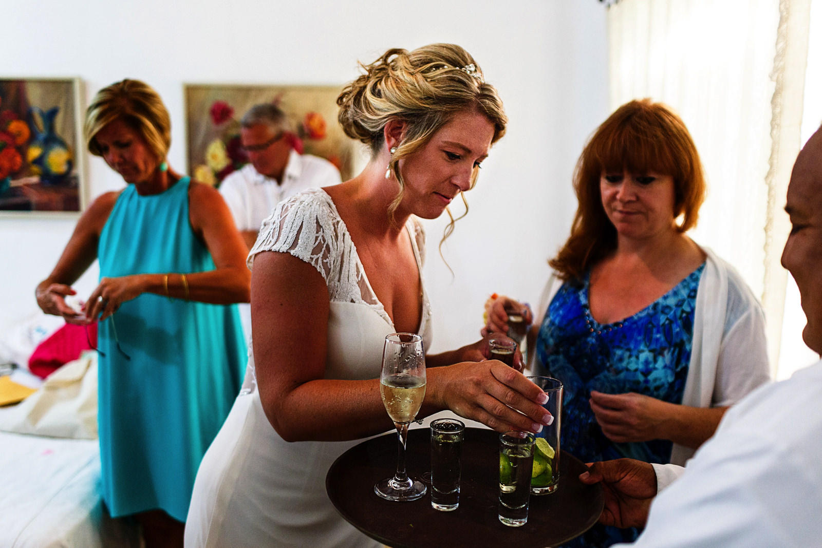 Bride and mother-in-law about to have a shot of tequila before the wedding ceremony