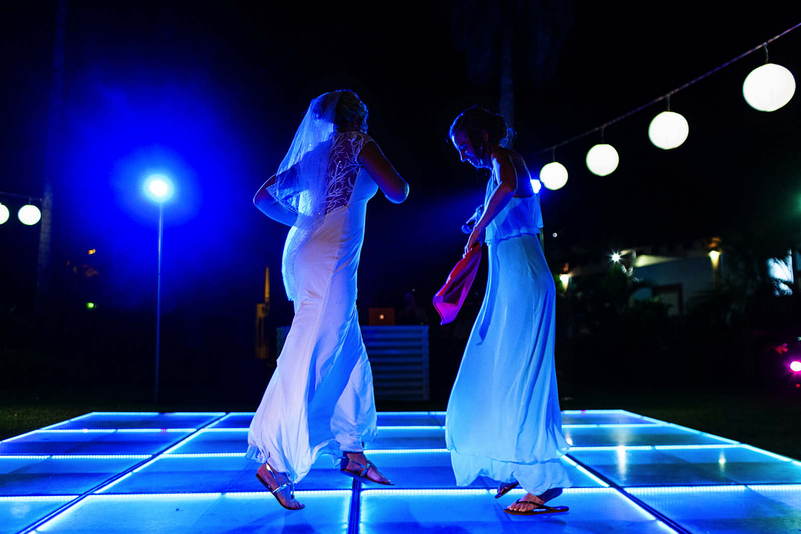 Bride and maid of honor dancing in the dance floor as part of the speech during destination wedding reception