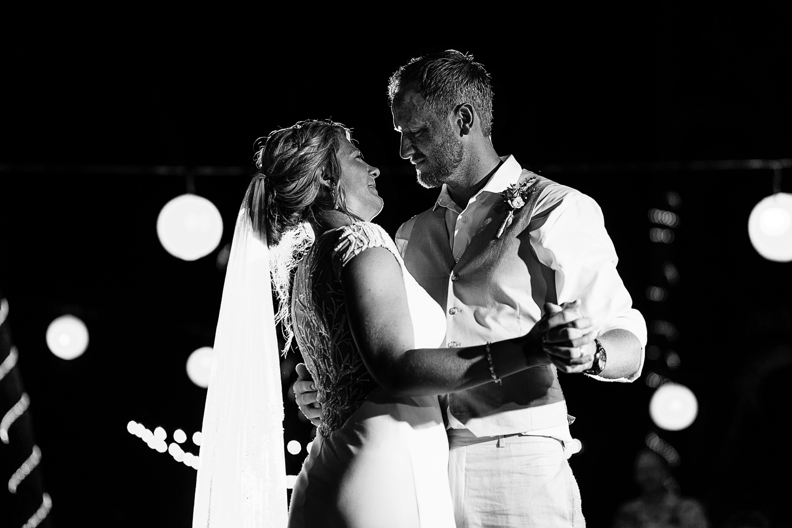 Bride and groom looking into each other eyes during their first dance