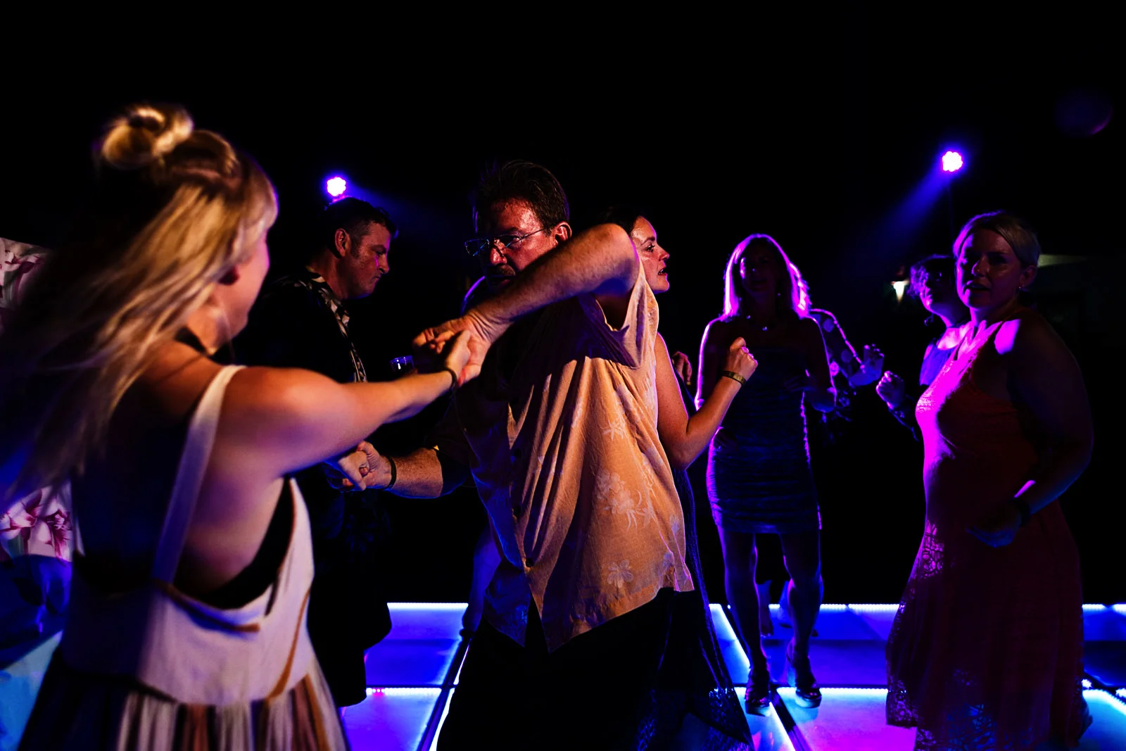 Wedding guest about to turn his partner on the dance floor