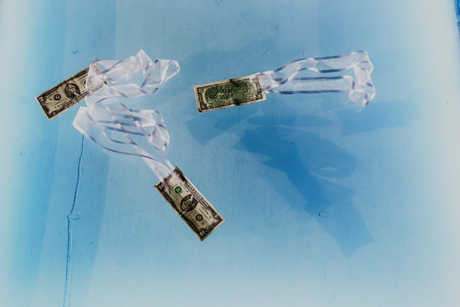 Three two dollar bills on the dance floor