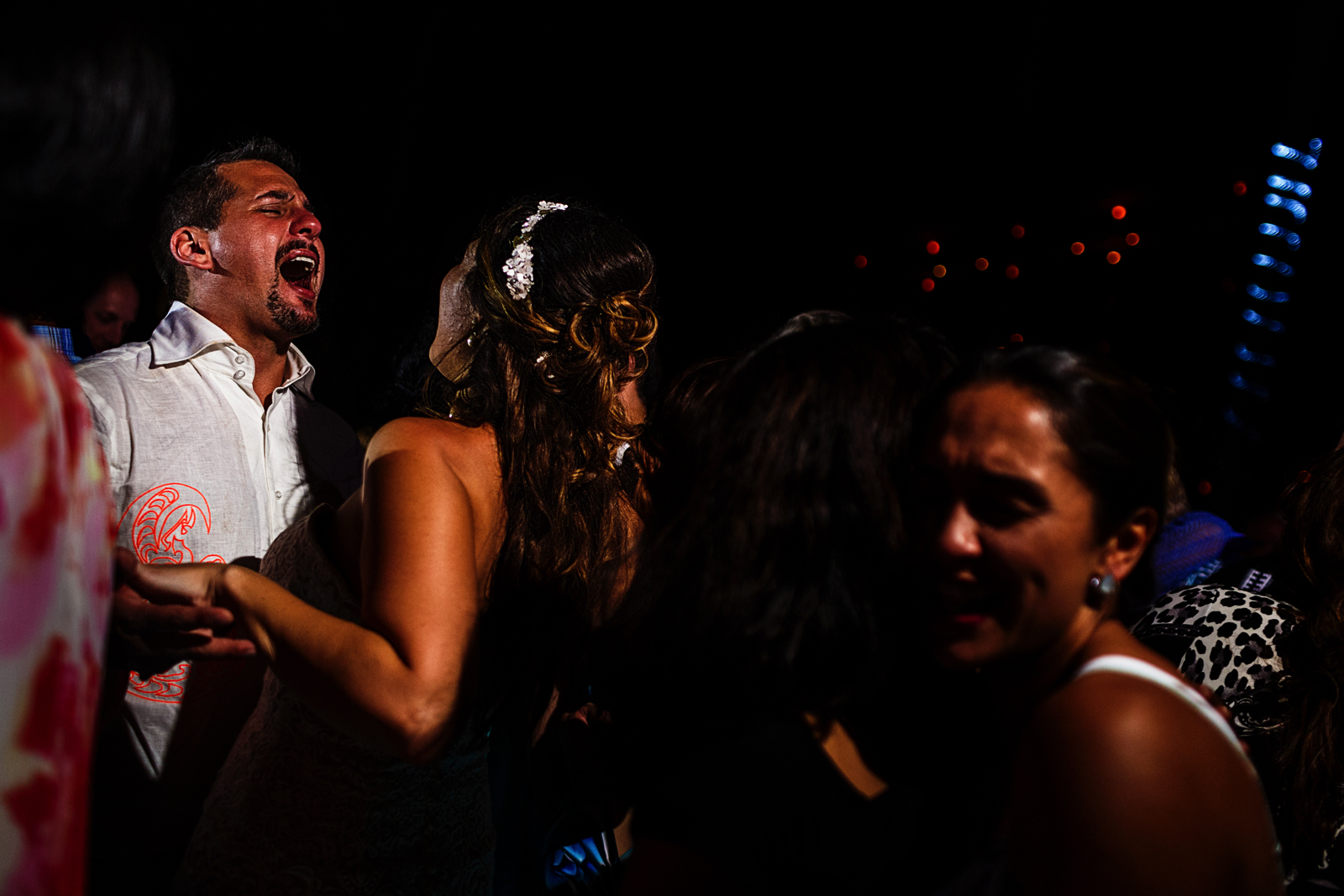 Groom singing while dancing with the bride in the crowd