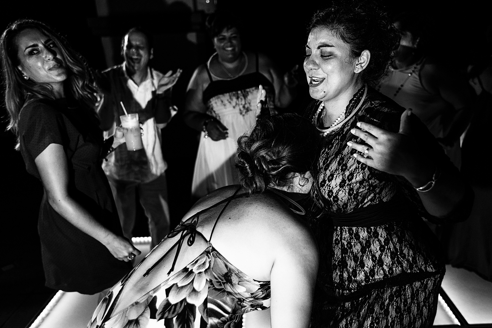 A girl rest her face on another guest's chest
