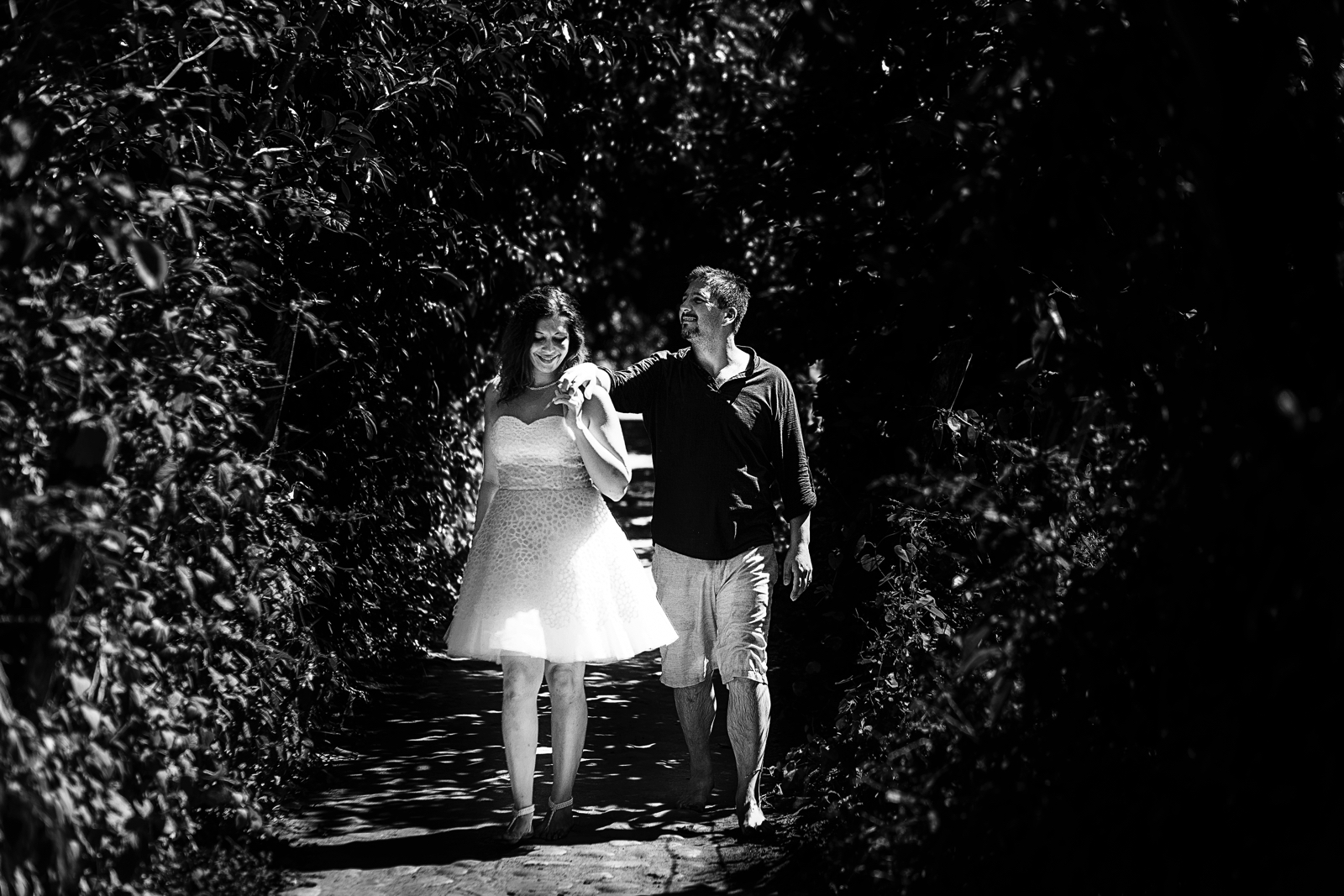 Couple walking thru a bushy path in Yelapa, Mexico