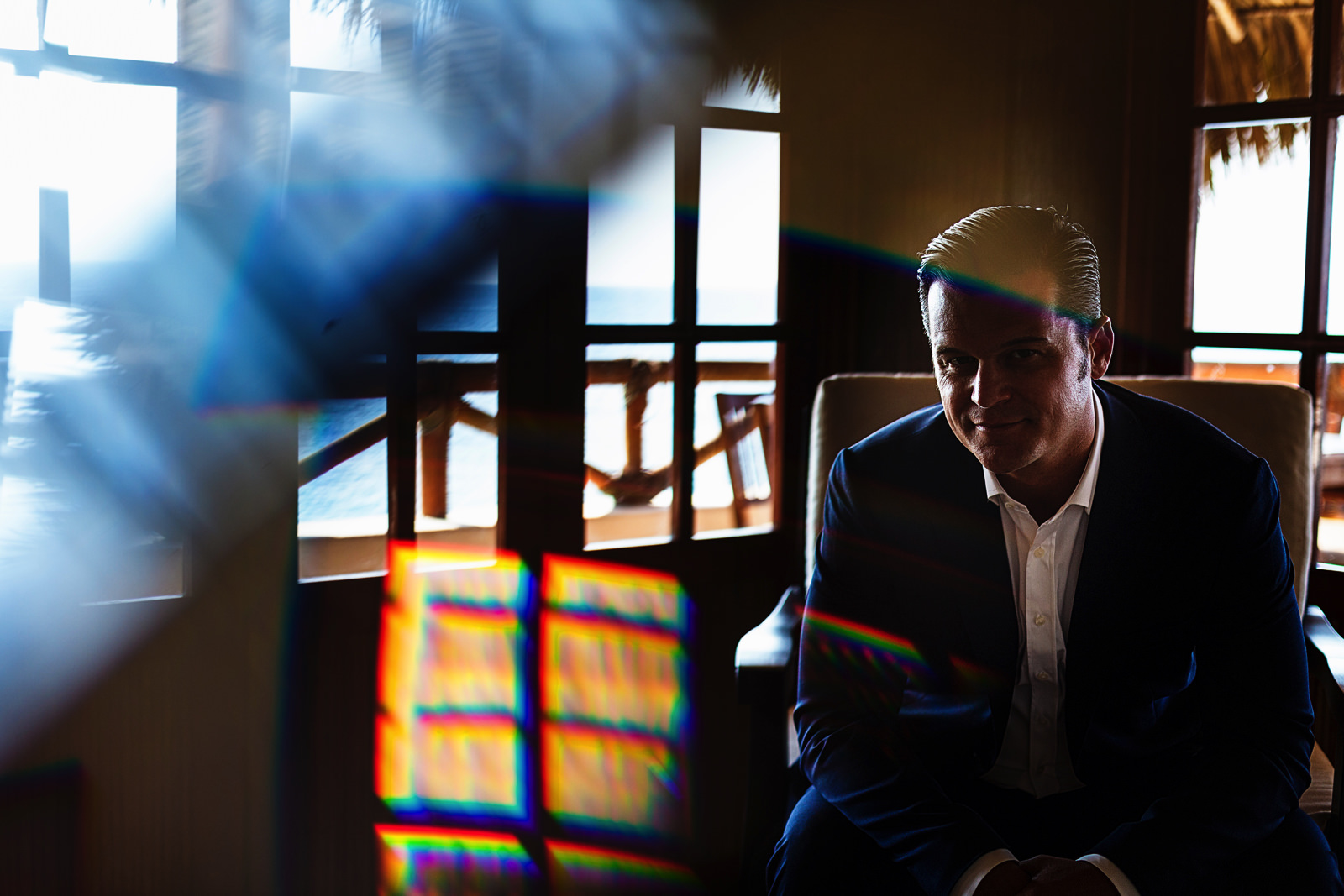 Portrait of the groom with some light effects from a prism