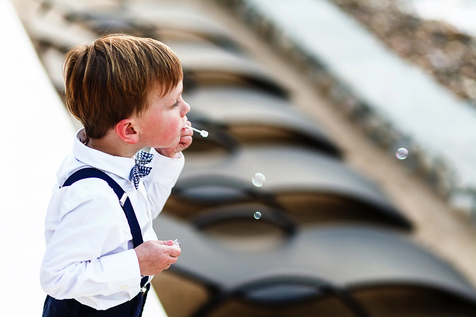 Toddler blowing bubbles on the beach