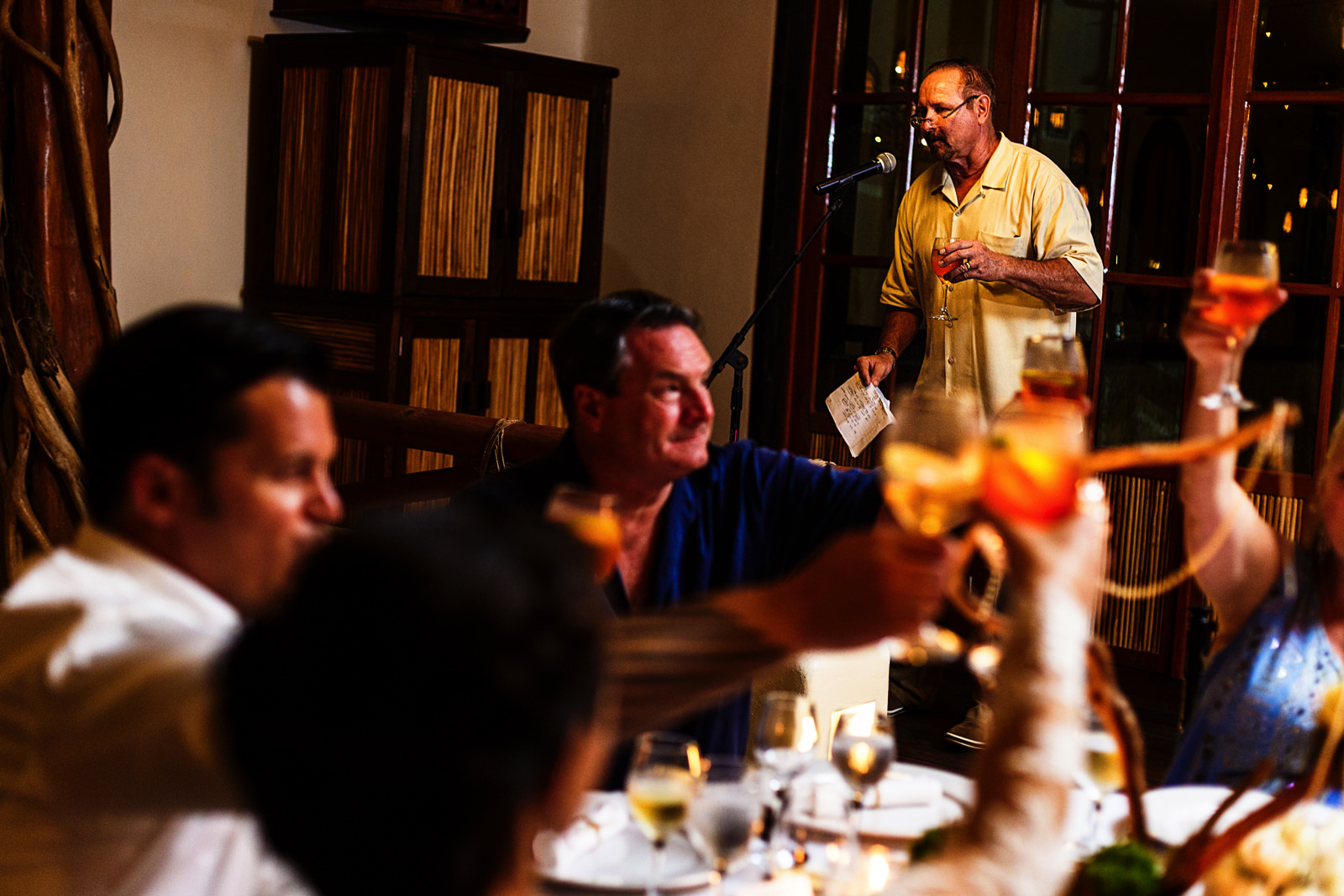 Everybody raise their glasses as the father of the bride toast for the wedding couple