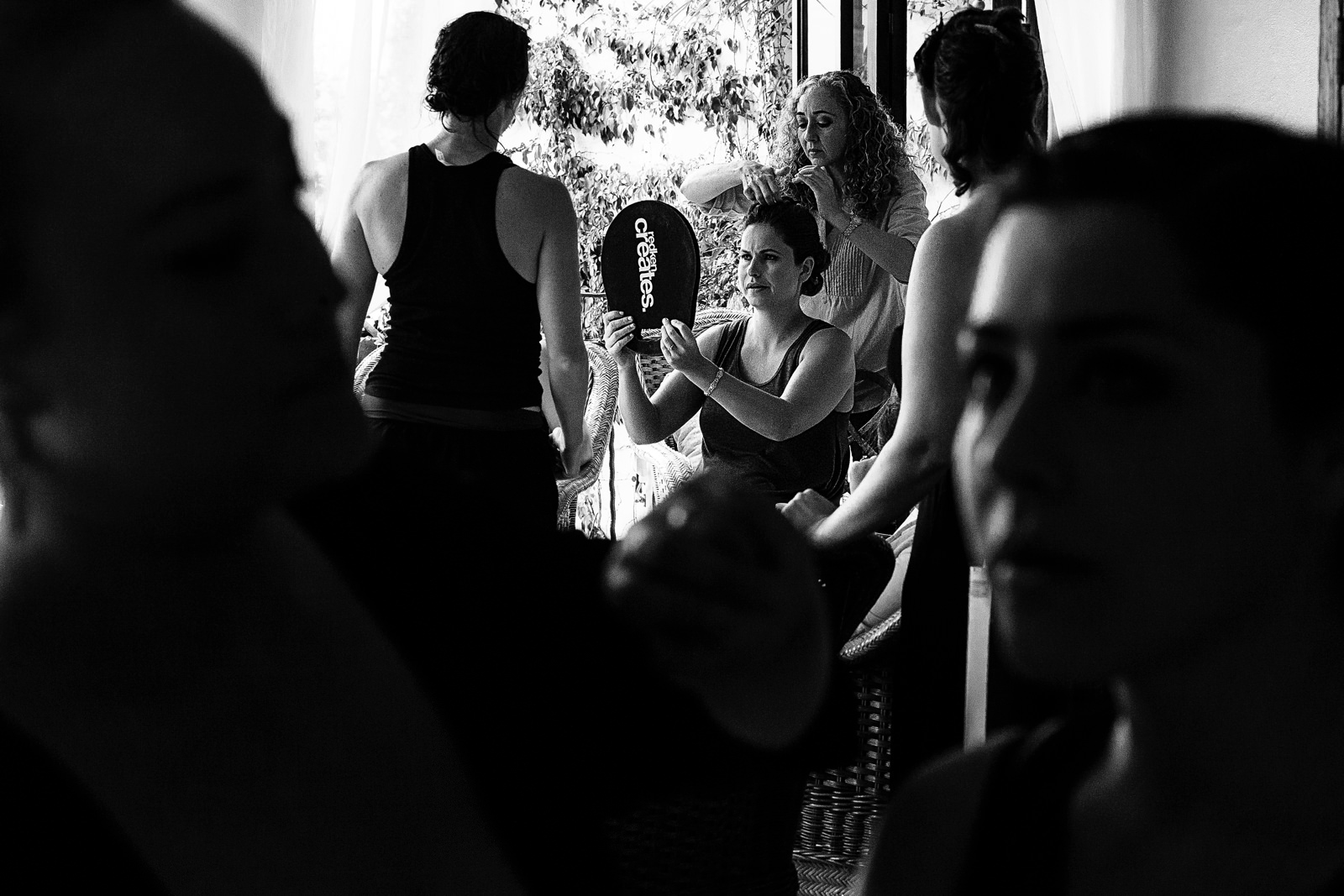Bride looking her make-up and hair in a mirror