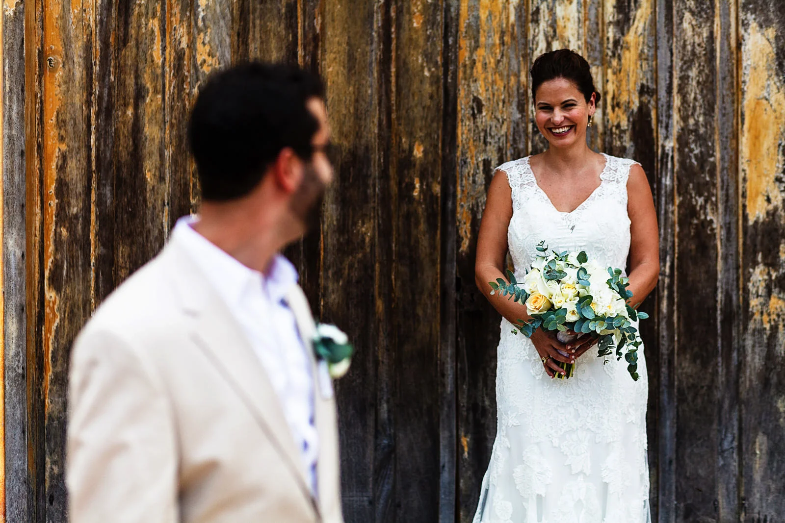 Portrait of a groom and bride on a door outside a tequila factory