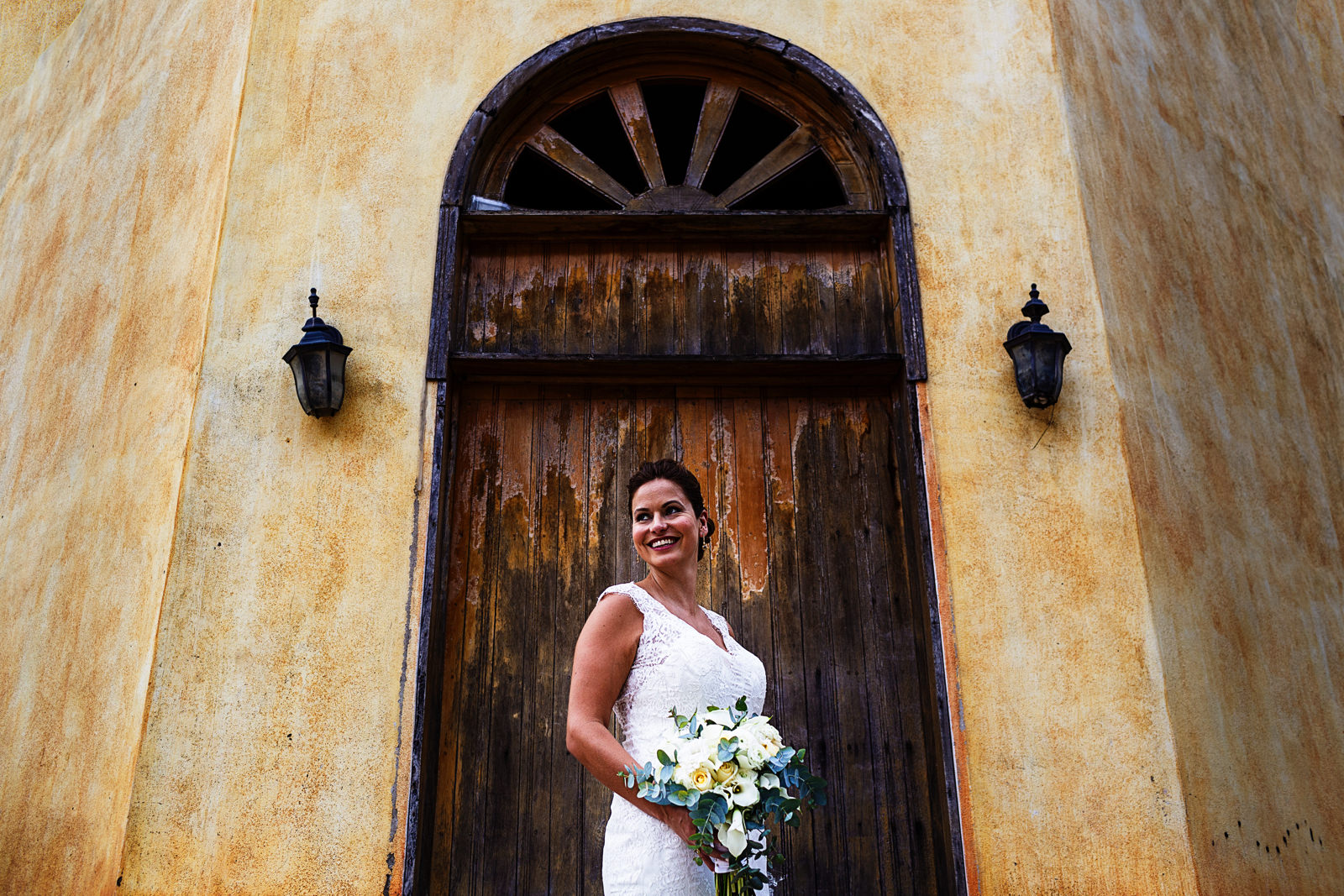Portrait of the bride on a door outside a tequila factory
