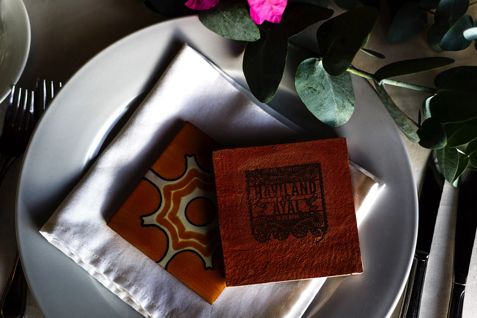 A Mexican tile for souvenir with a stamp in black ink with the names of the wedding couple