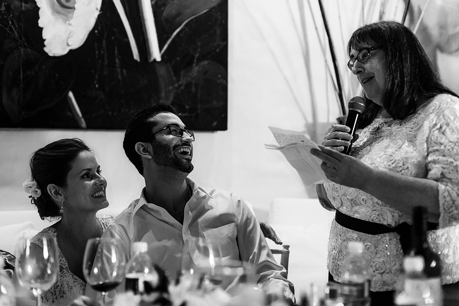 Mof the groom giving a speech, groom and bride laughing for said words