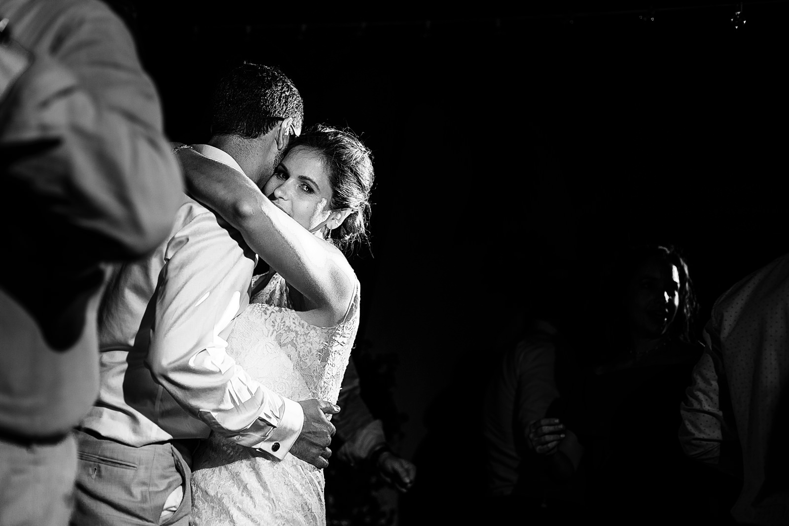 Destination wedding couple hugging and dancing during their reception party