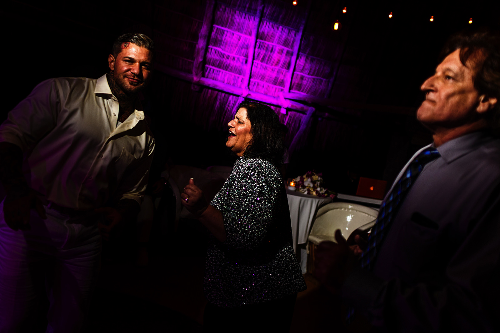 Groom dance with mom and dad at the reception of his destination wedding in Mexico
