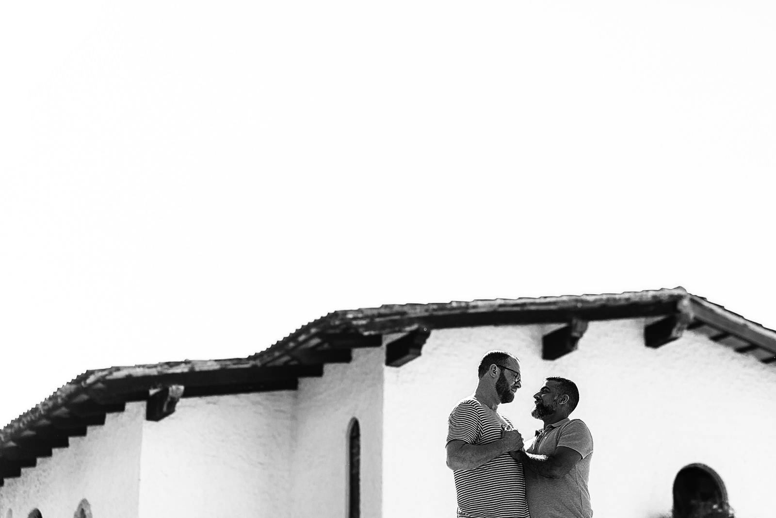 Couple facing each other framed on a wall in black and white, destination wedding photography