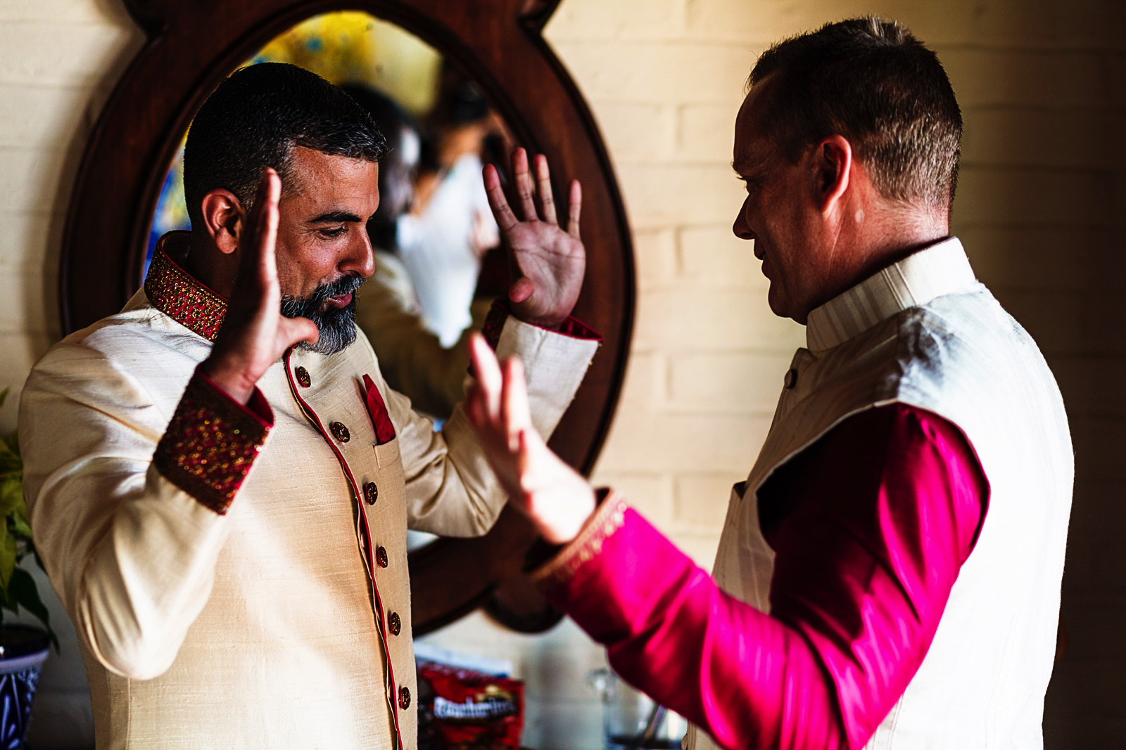 Hands explote as part of the groom and best man preparation ritual