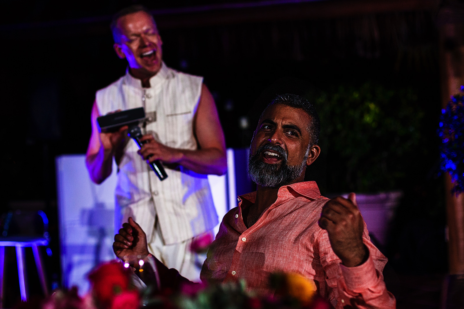 Best man holds a boombox against the microphone on his speech, the groom reacts singing