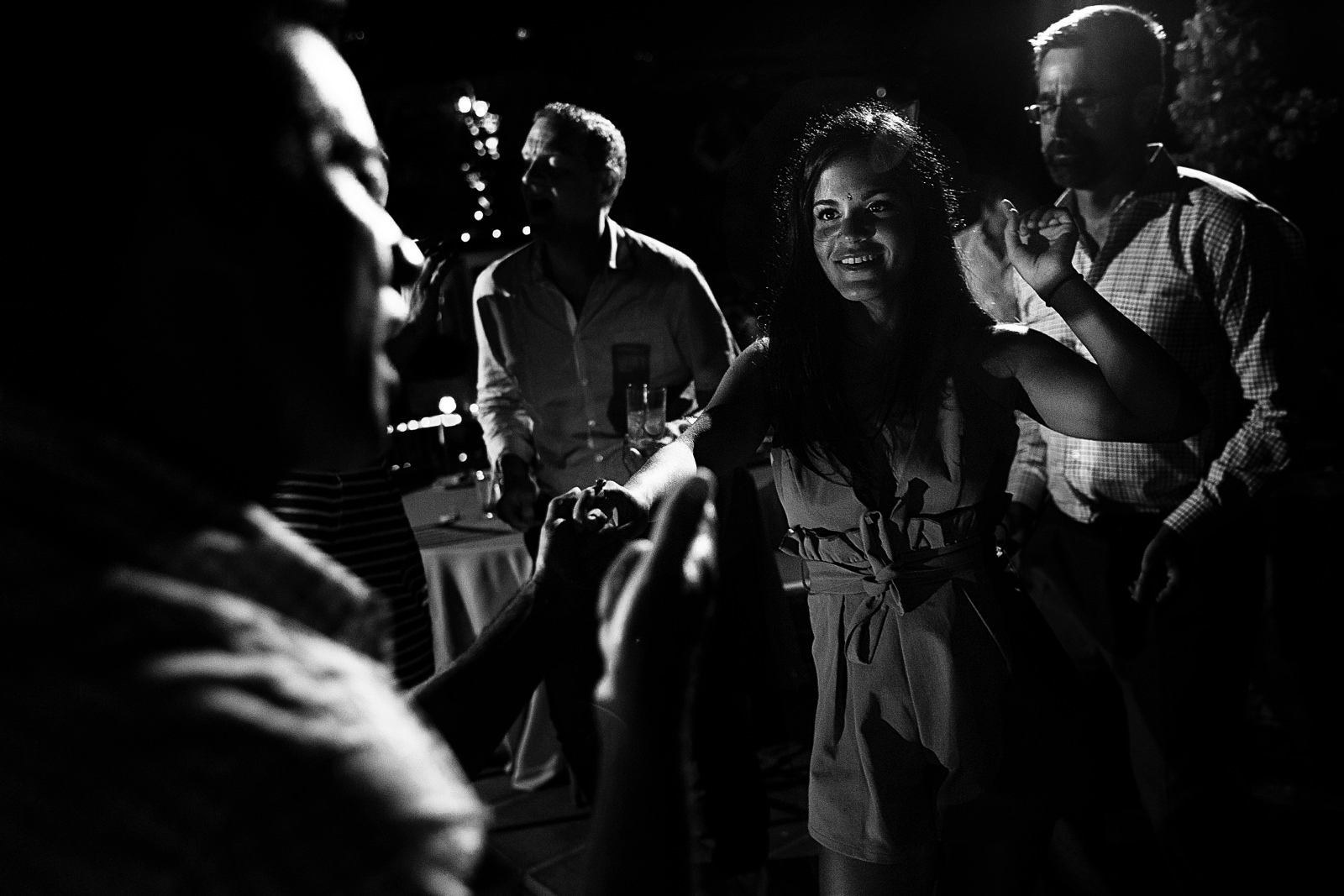 Guests dance and sing on the wedding reception