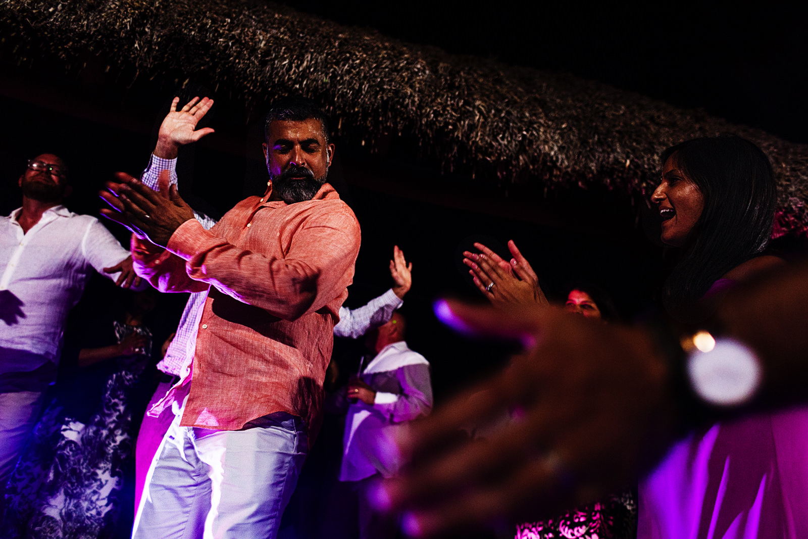 Groom dances hindi music style around the wedding guests clapping