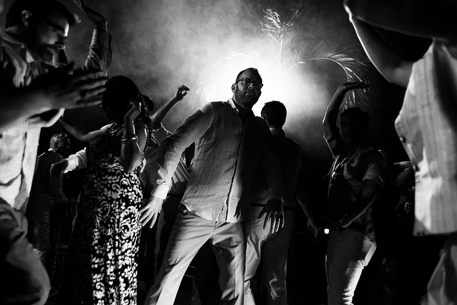 Groom dances with wedding guests during the party