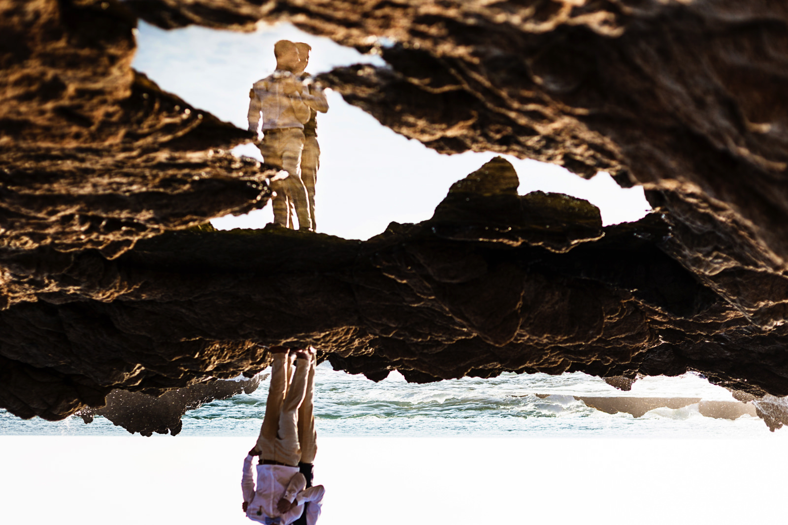 Gay couple portrait on their destination wedding in Mexico, upside down and reflected in the water