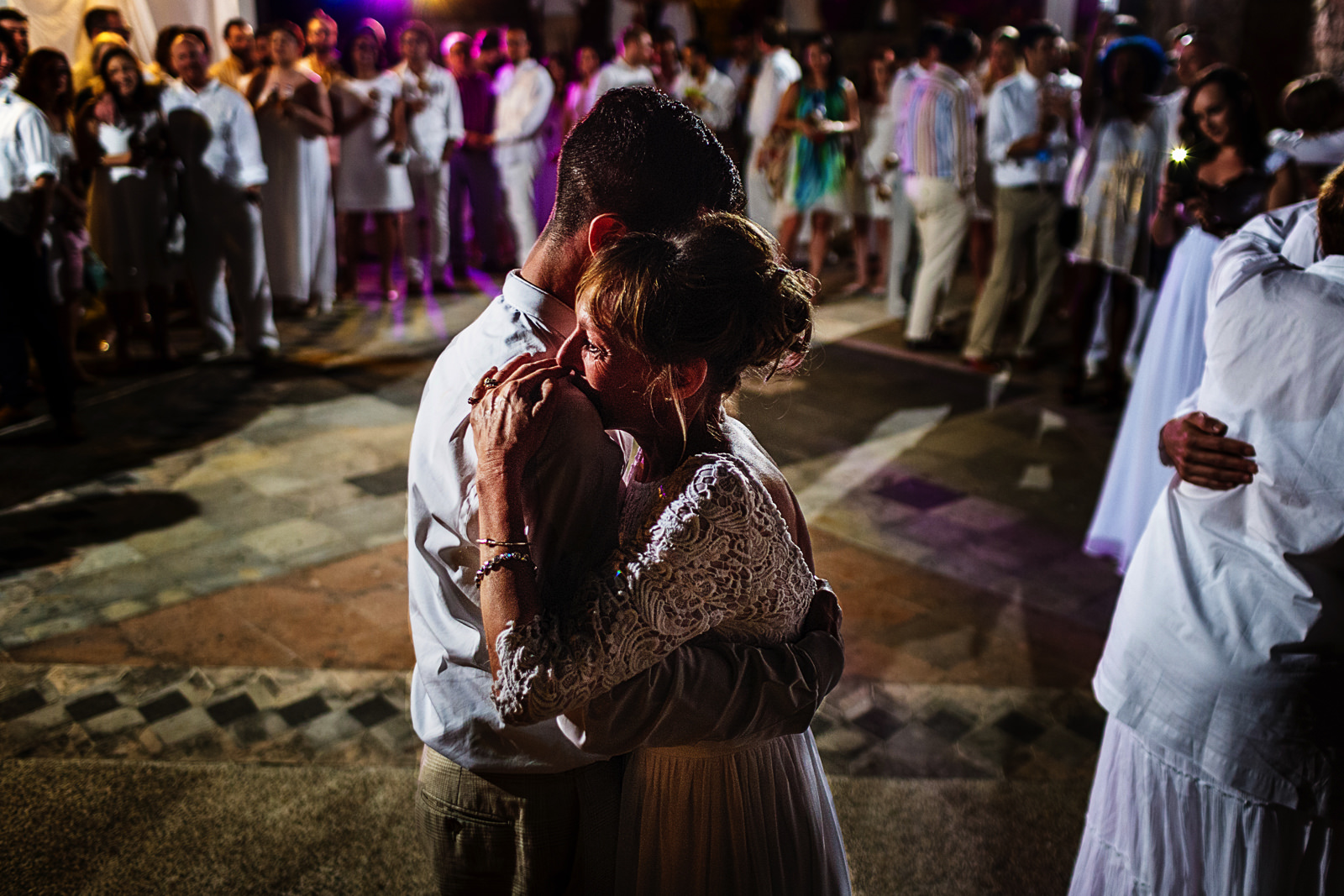 Groom and mother dance in wedding reception in the middle of all the guests and family