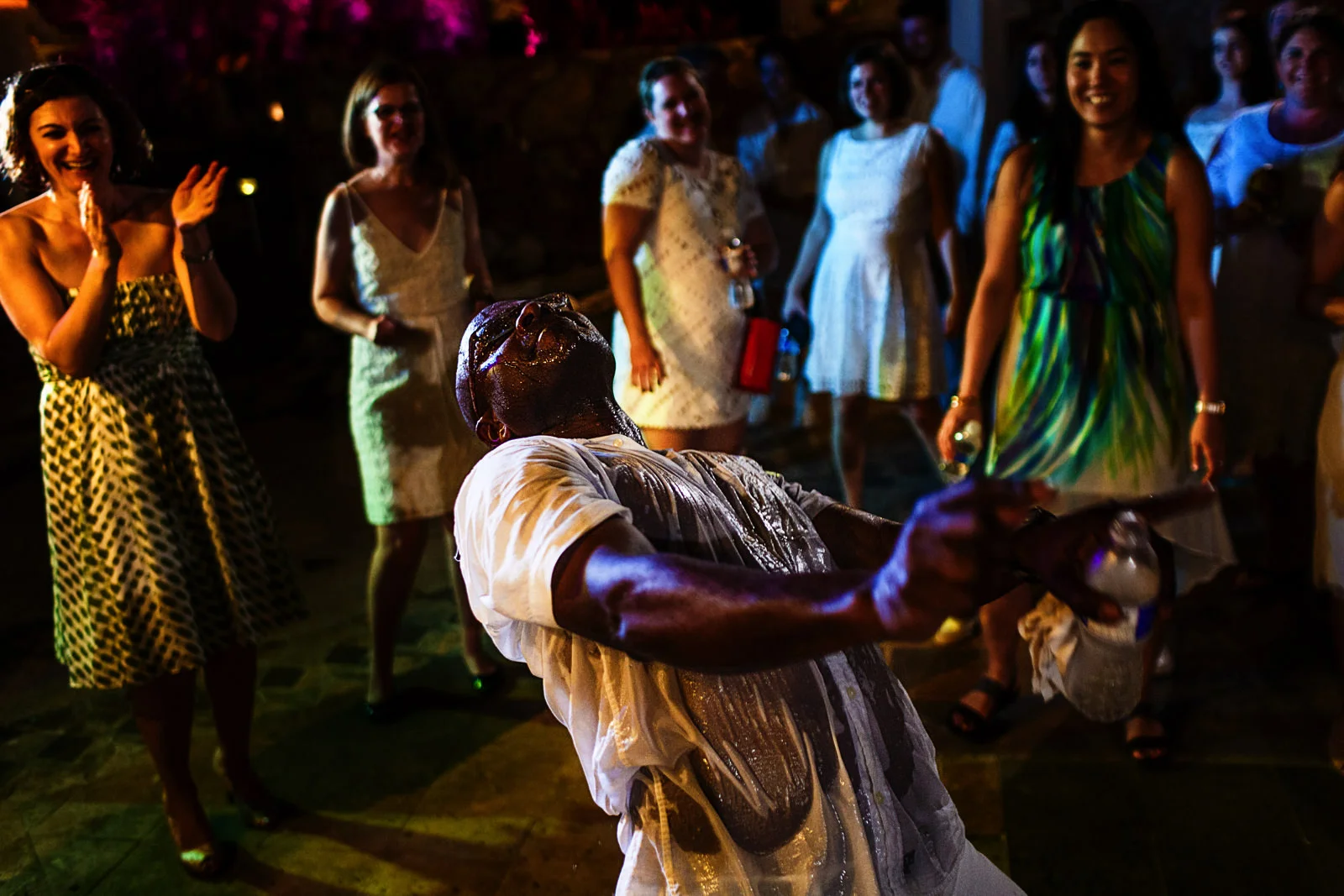 Wedding guest soaked wet dance intensively while other guest laugh and enjoy