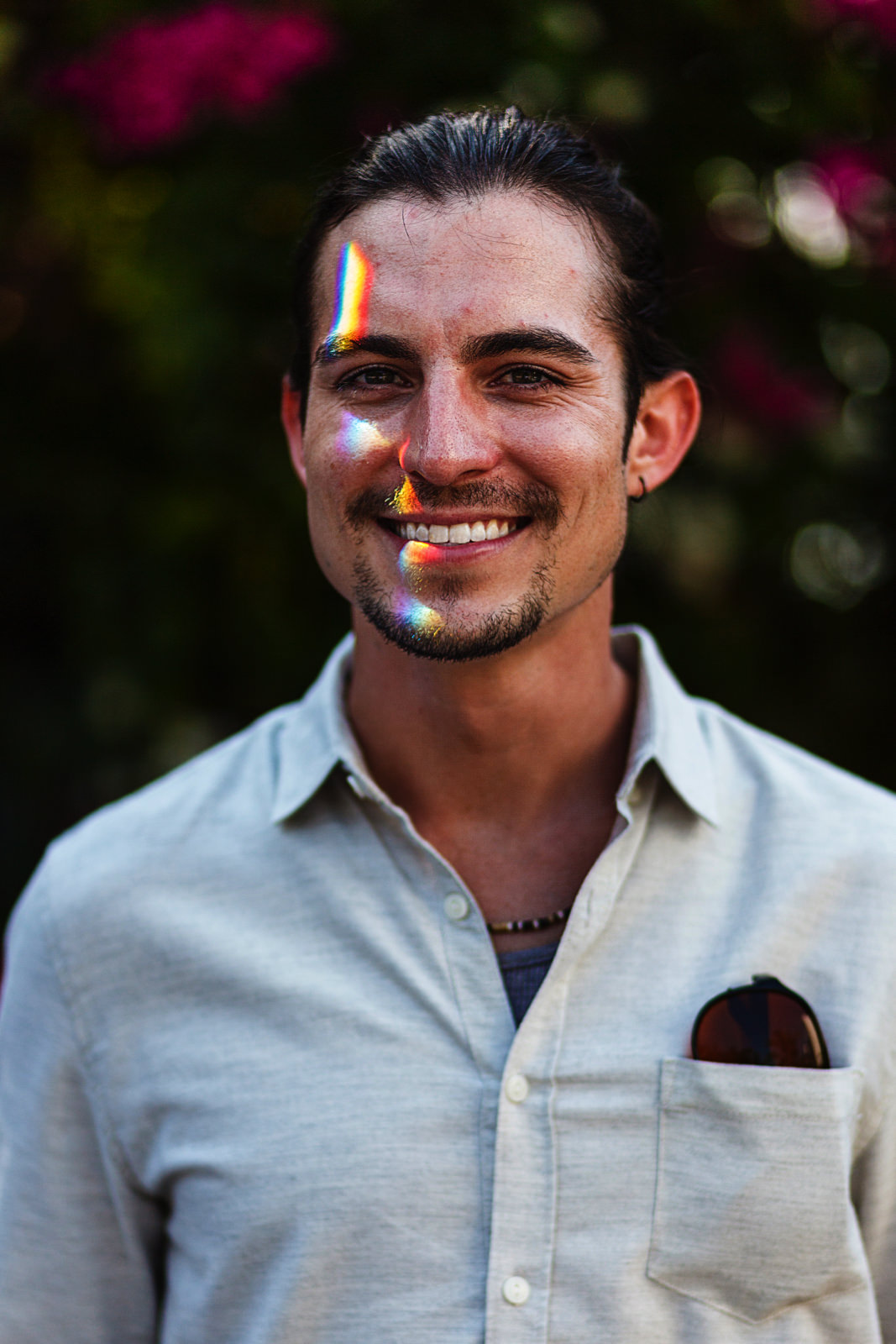 Groom portrait with a prism light on his face