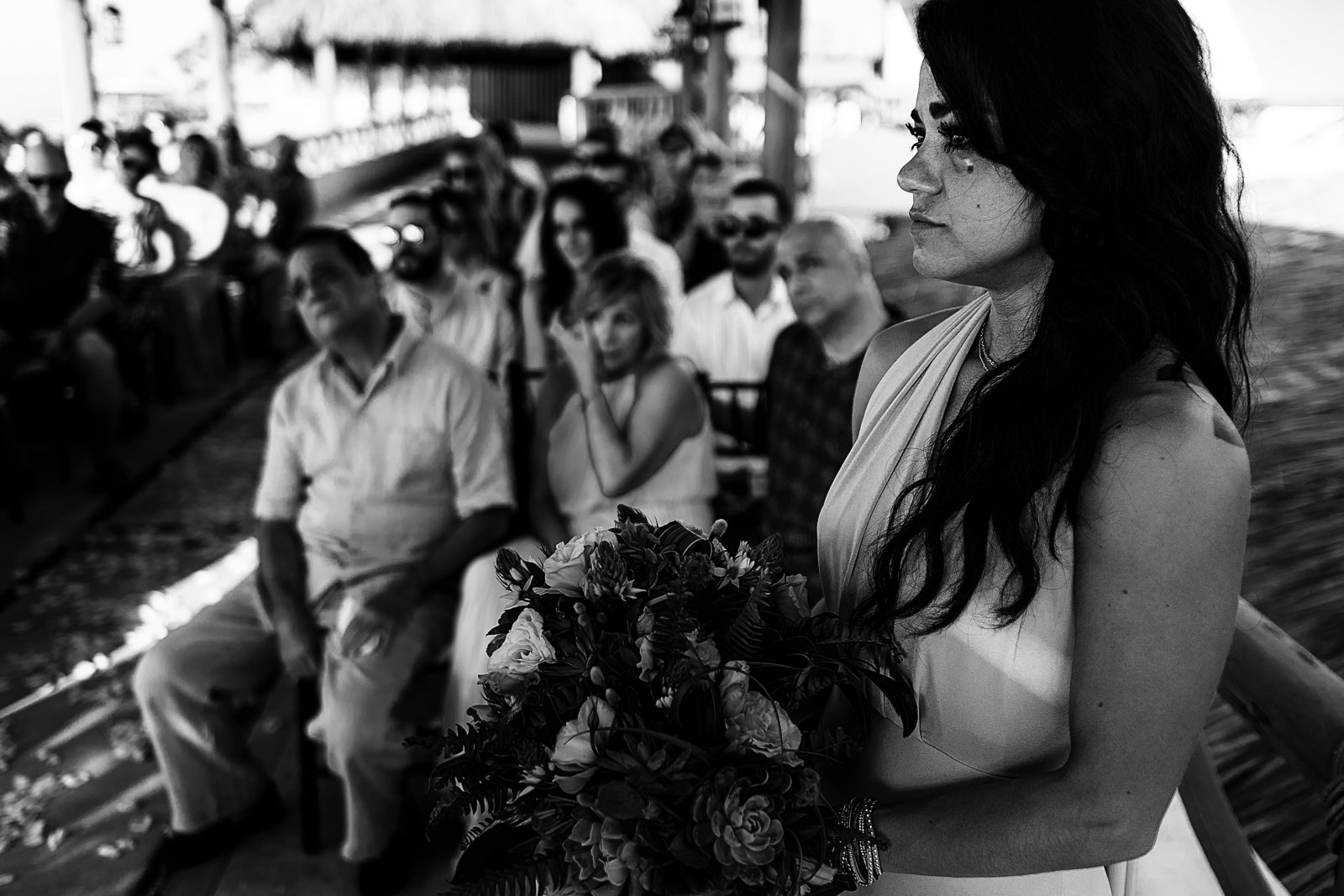 Maid-of-honor crying during the wedding ceremony, the mother of the bride can be seen also crying in the background