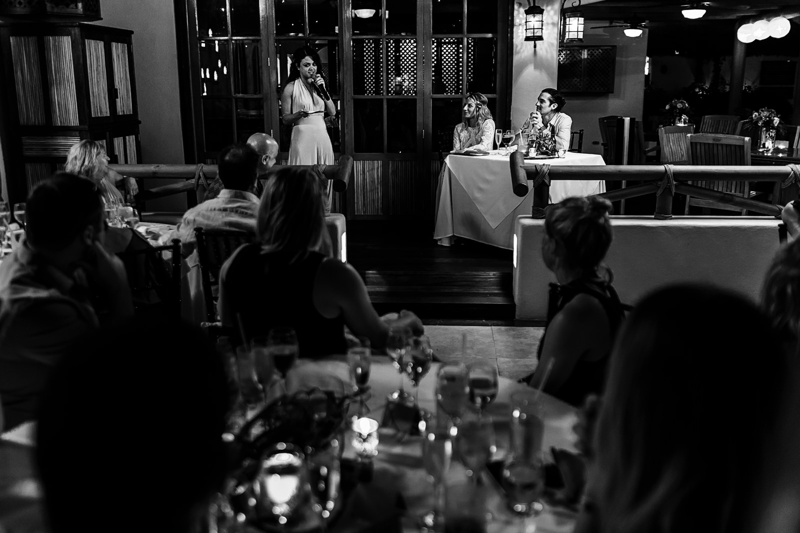 Maid of honor giving a speech to the groom and bride on their wedding reception