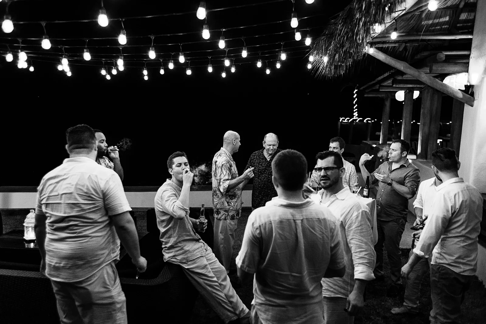 Wedding guests having cigars on the grass area of Playa Fiesta Hotel