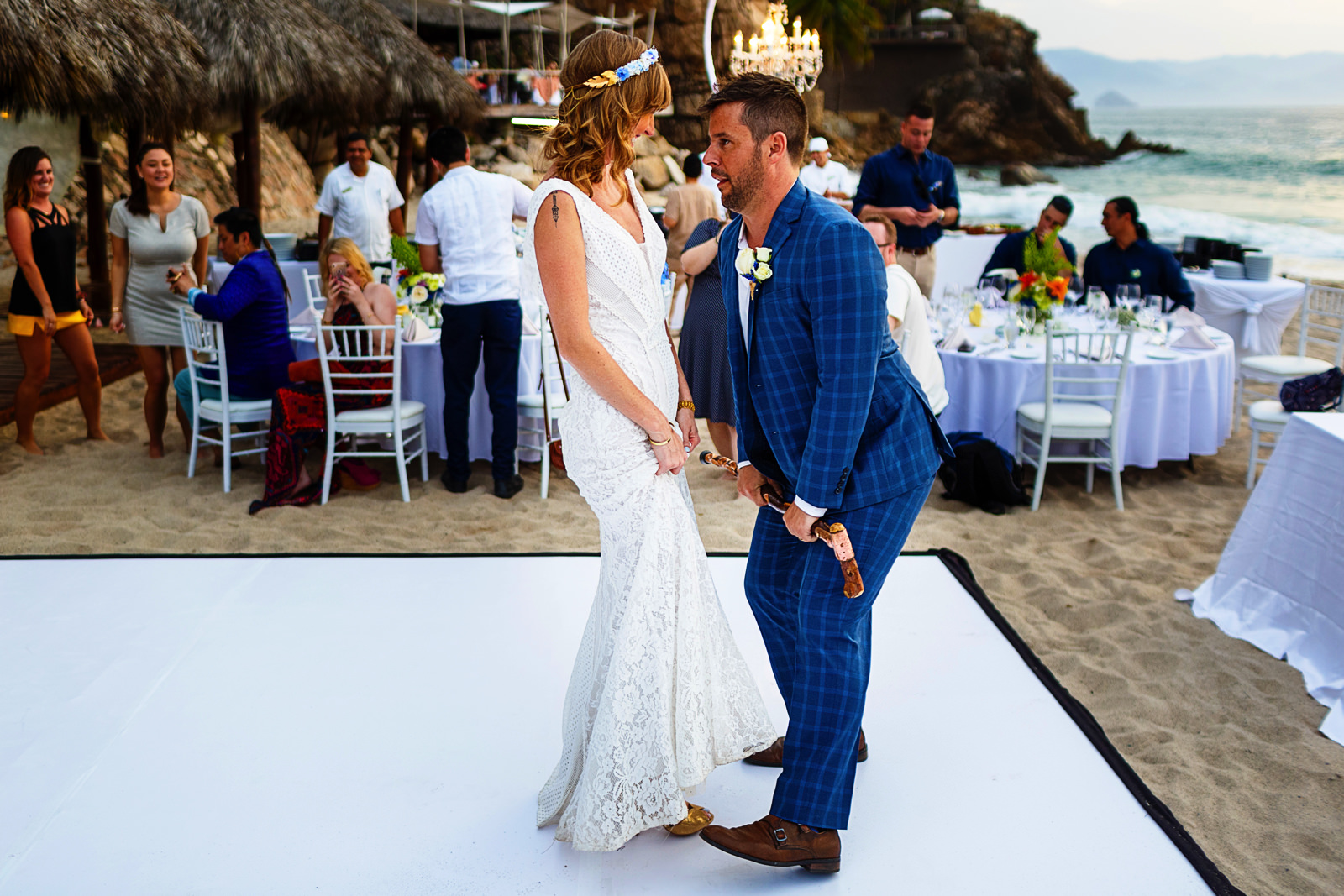 Bride and groom dance as part of their entrance into the reception on the beach