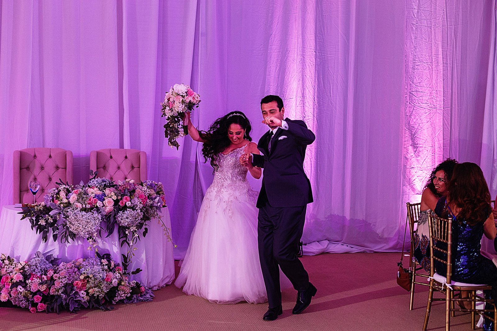 Groom and bride dancing entrance to the ball room for the reception.