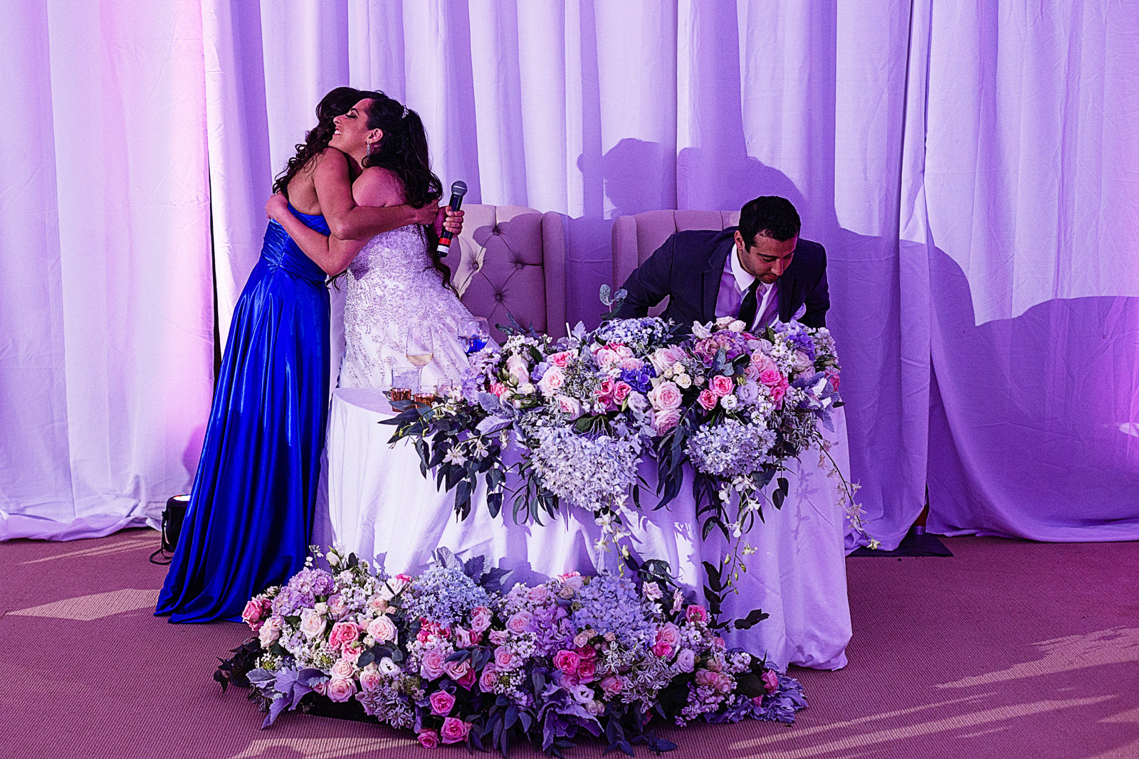 Maid of honor hugs the bride at the end of her speech.