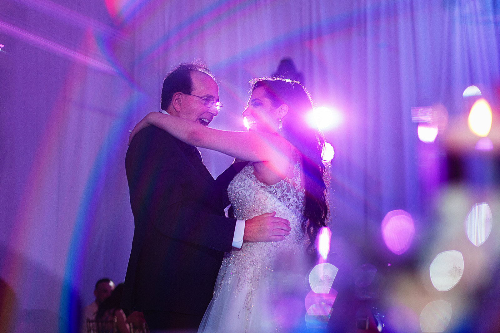 Bride and her dad dancing during the wedding reception, image taken through a prism.