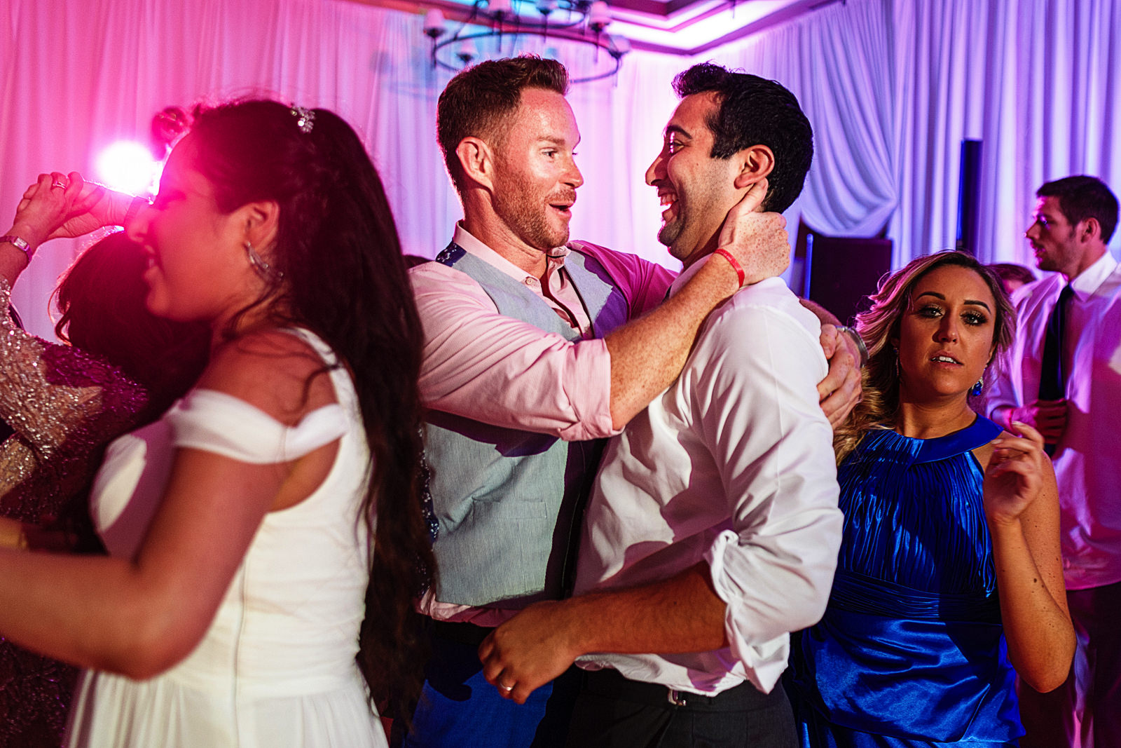 Groom having a good time with a guest on the dance floor.