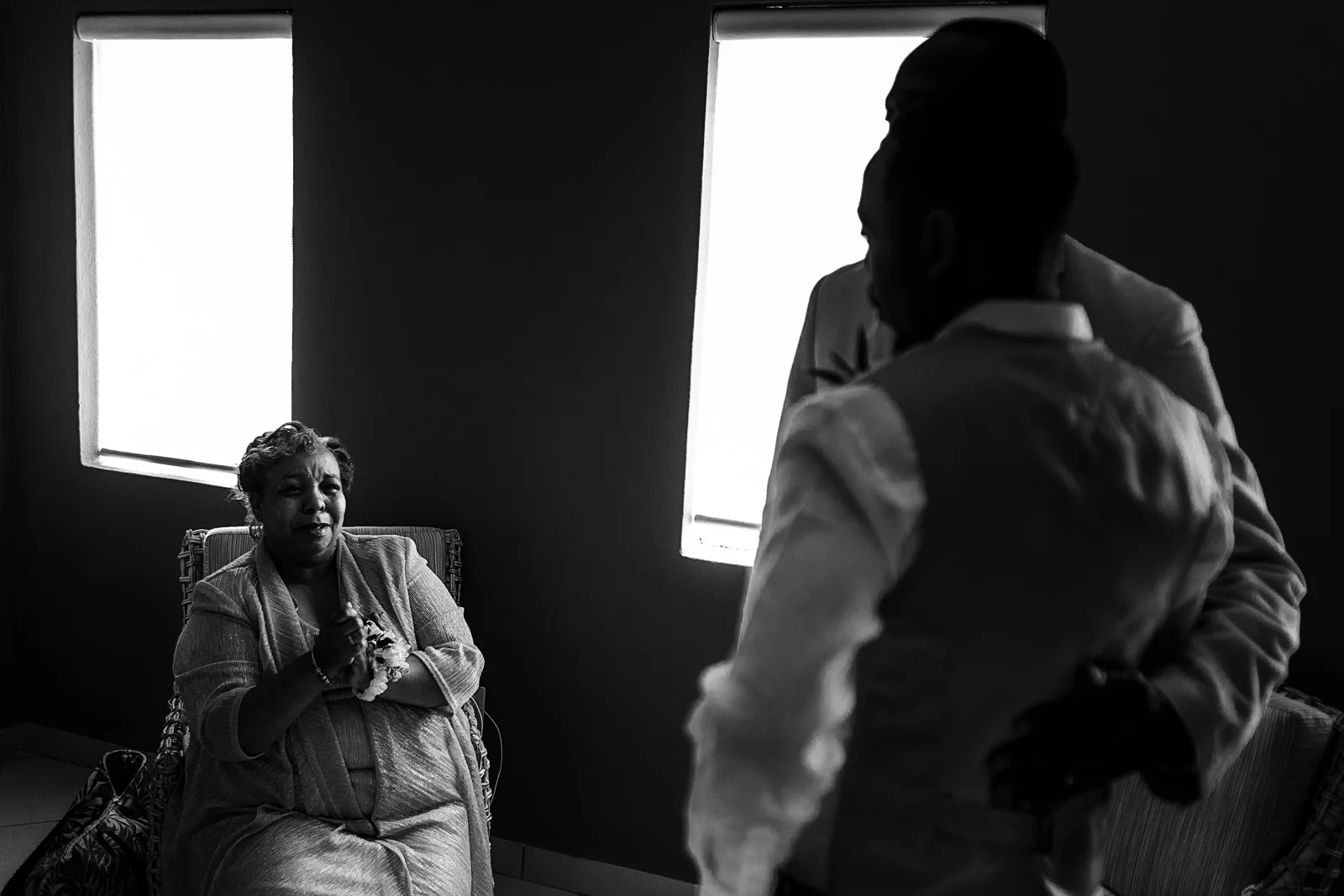 Mother of one of the grooms comtemplate the moment before the wedding ceremony.