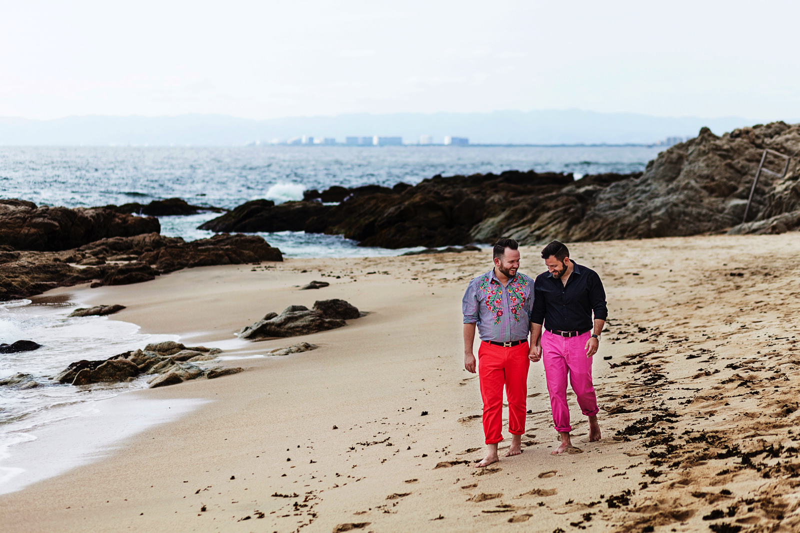 gay-couple-walking-sand-conchaschinas