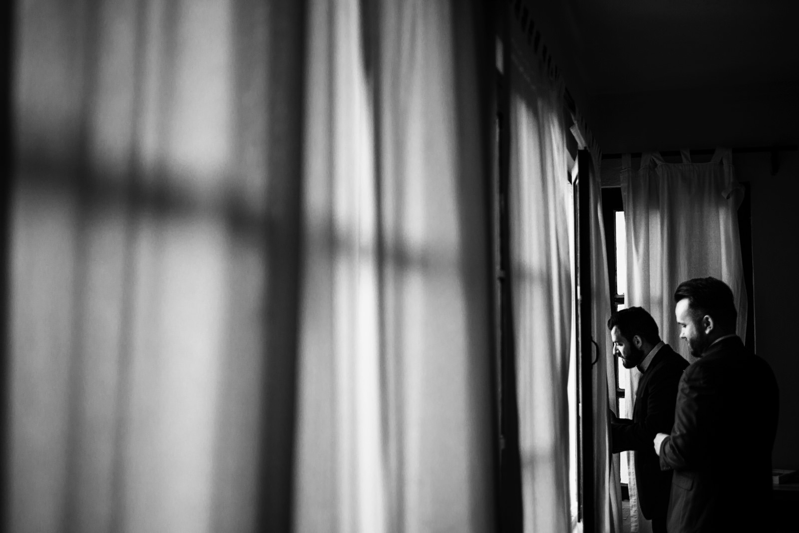 gay-couple-grooms-looking-through-window