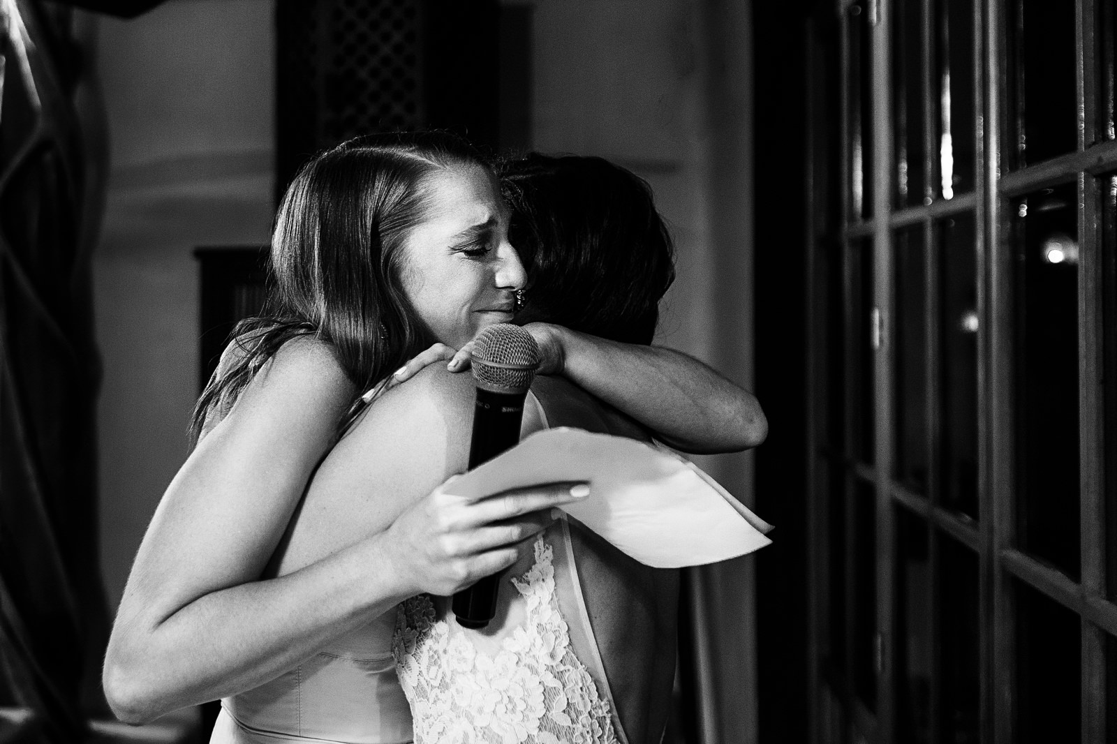 Maid of honor hugs the bride