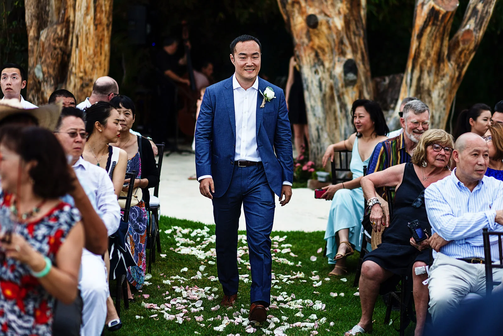 The grooms walks down the aisle to begin the wedding ceremony.