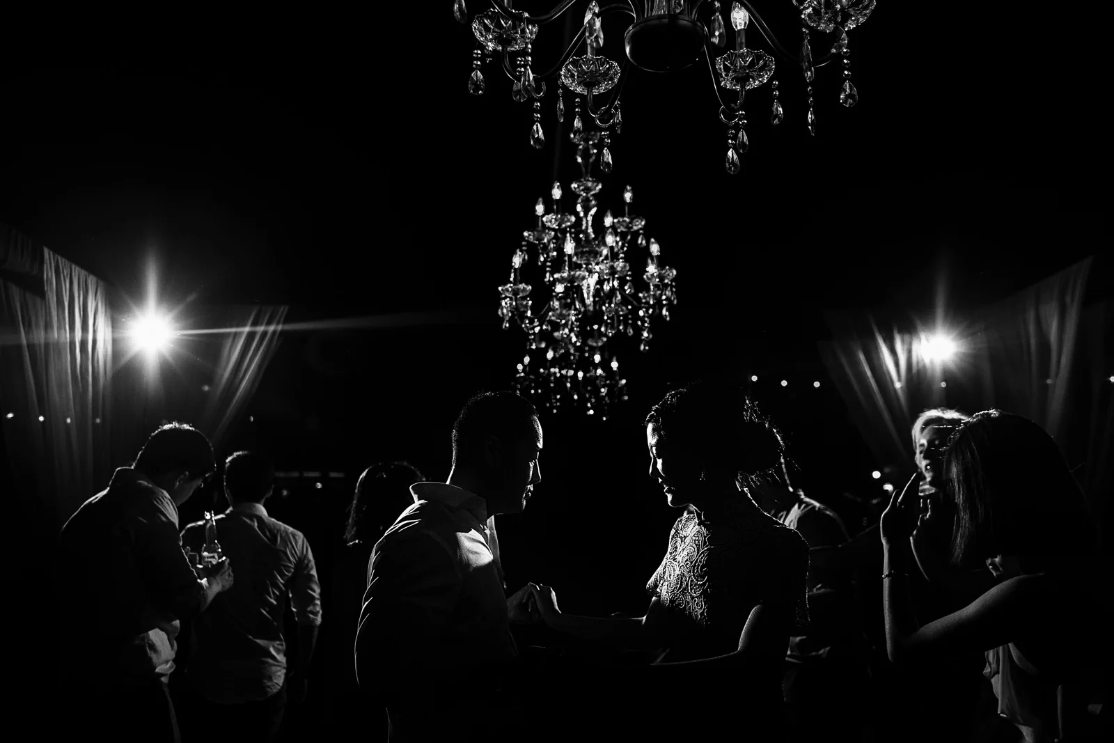 Groom and bride dancing in the middle of all of their friends and family during the party of their wedding.