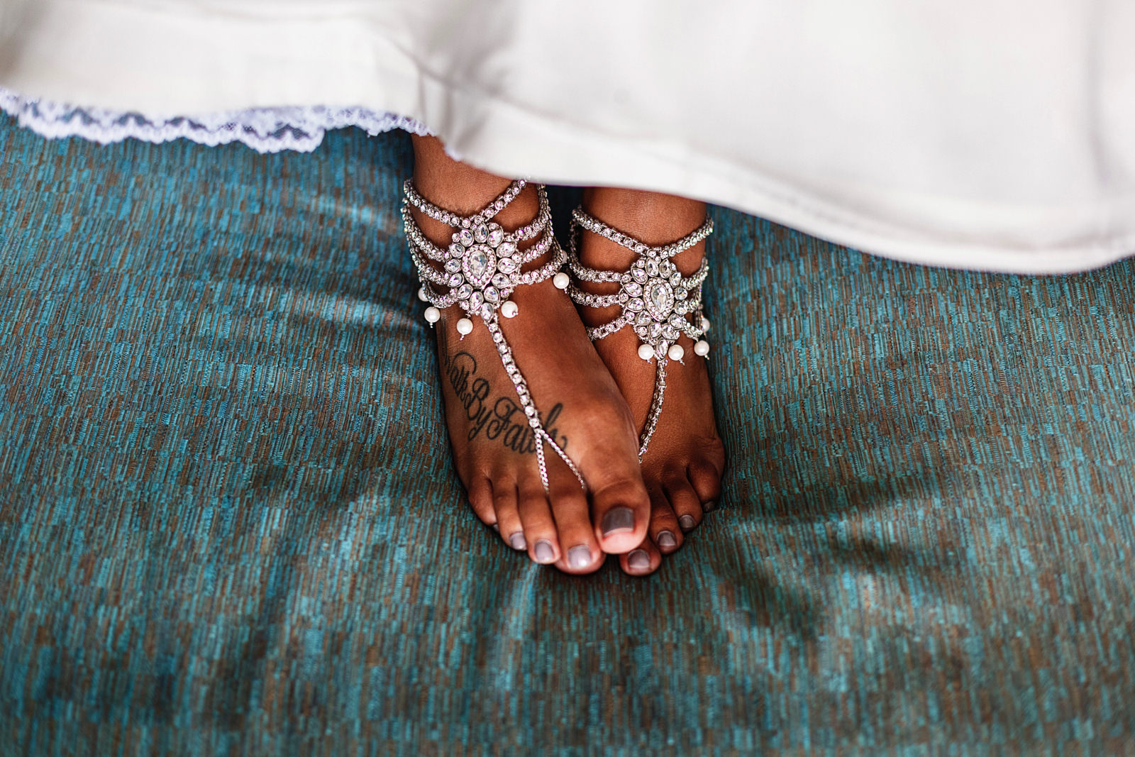 The feet of the bride wearing foot sandals over the sofa at a Hyatt Ziva bedroom