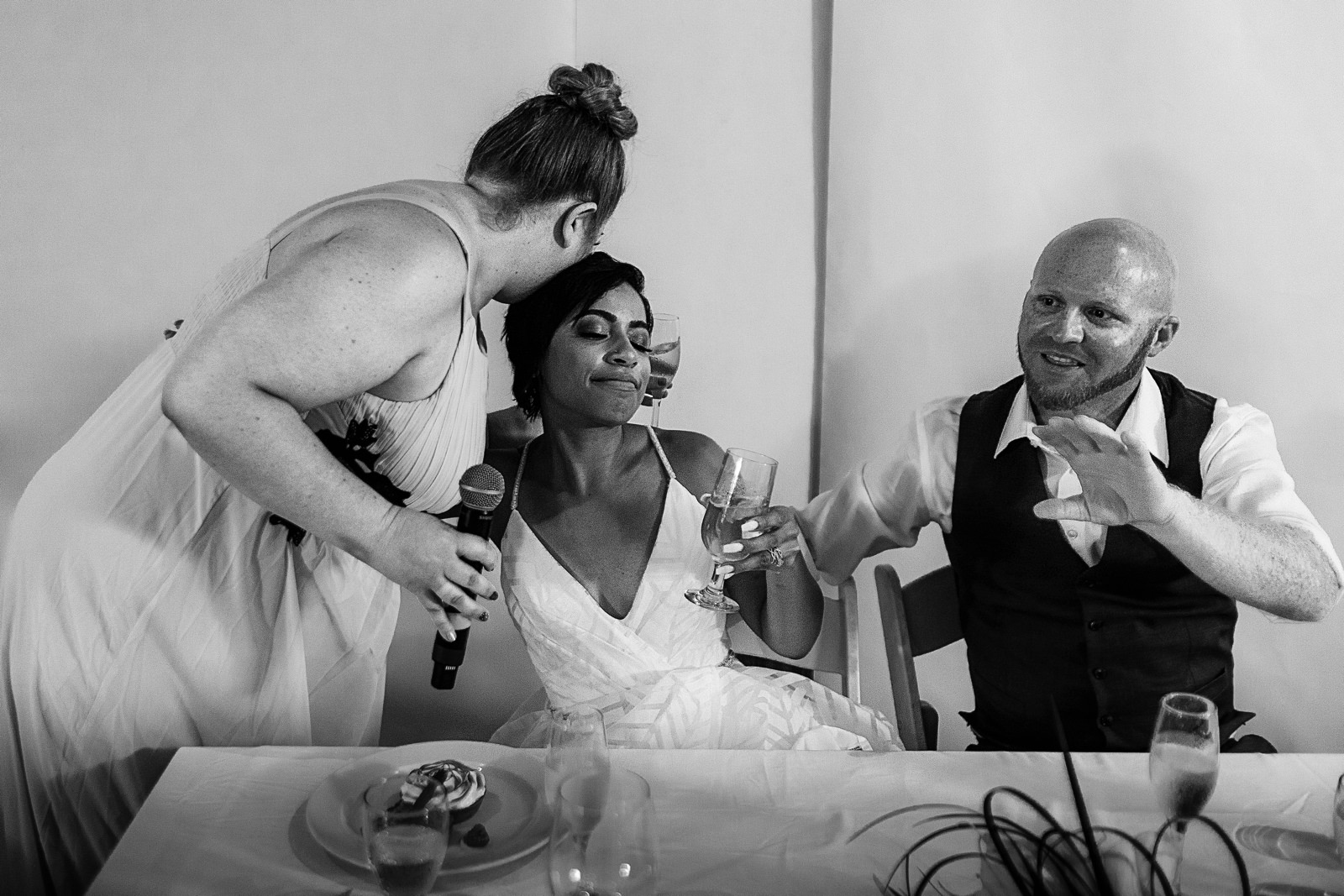Wedding guest kisses the bride in the head after her speech