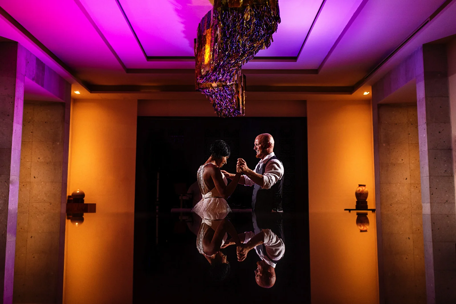Couple in their first dance as married couple reflected into the table at the Hyatt Ziva ballroom