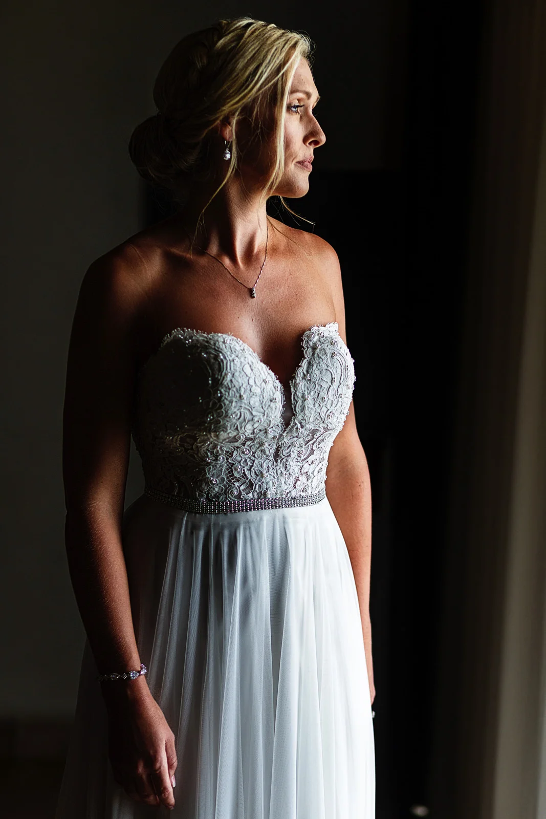 Bride's portrait standing close to a window