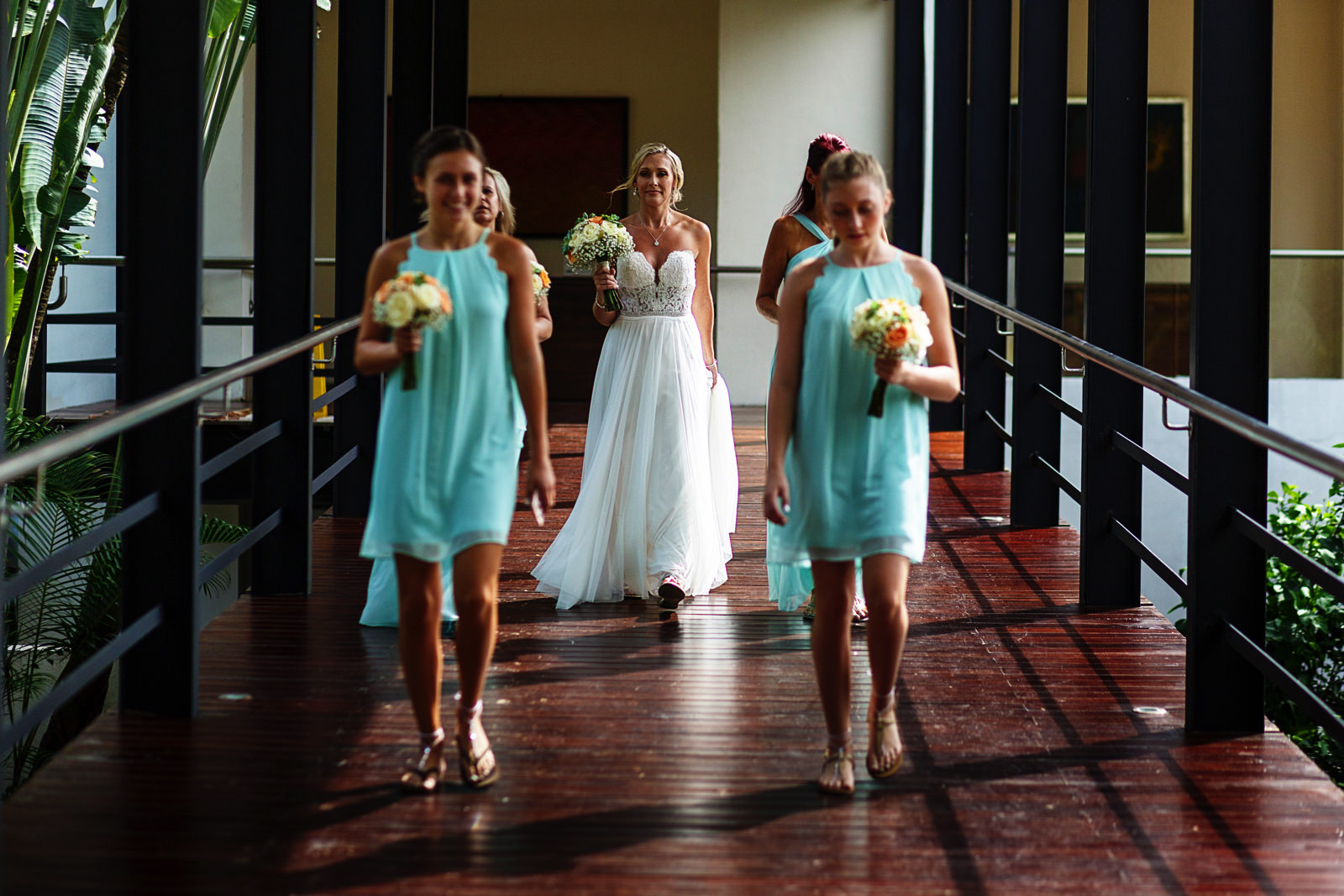 Bride walking through the bridge at Hyatt Ziva with all of her bridesmaids