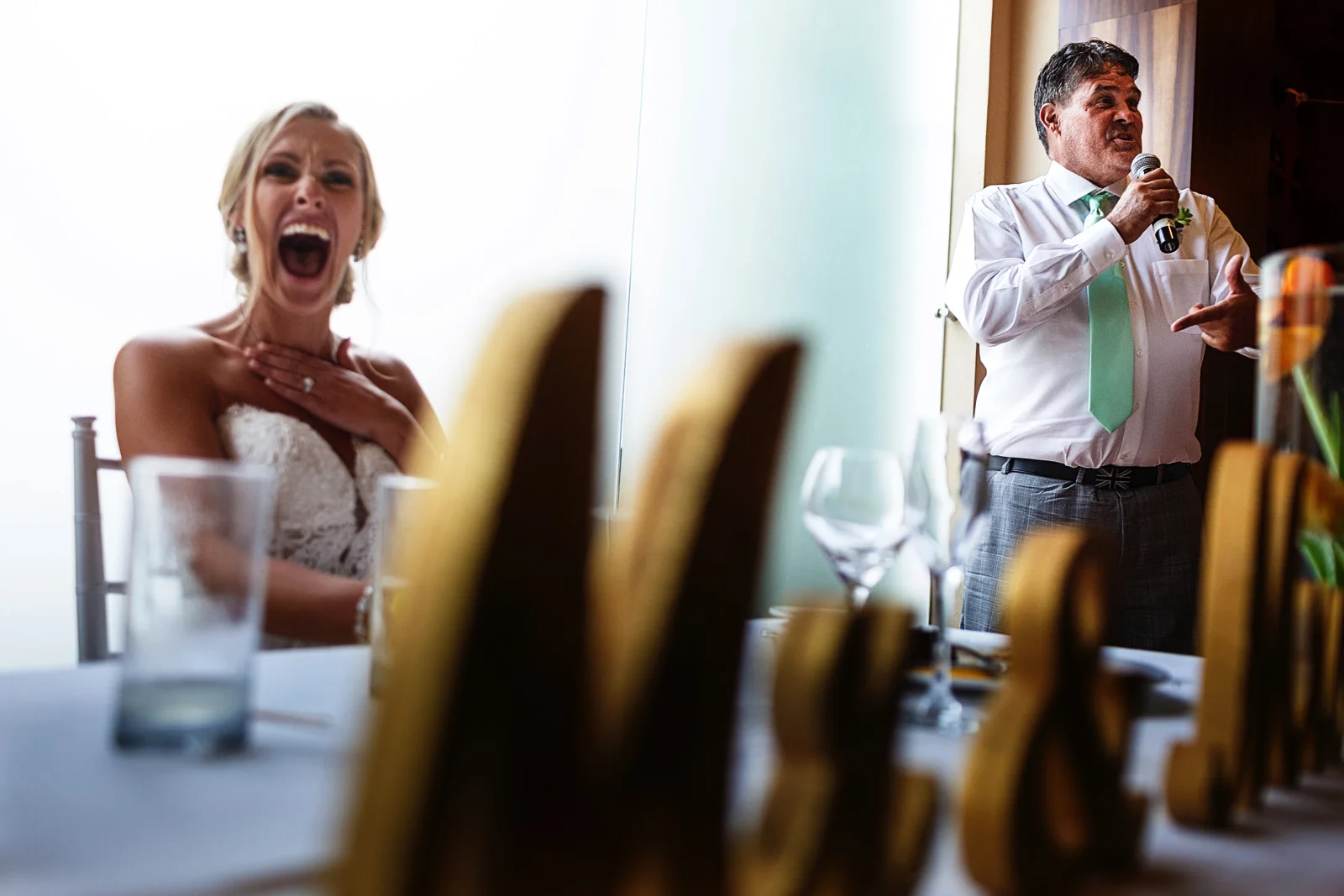 Bride laughs during groomsman speech