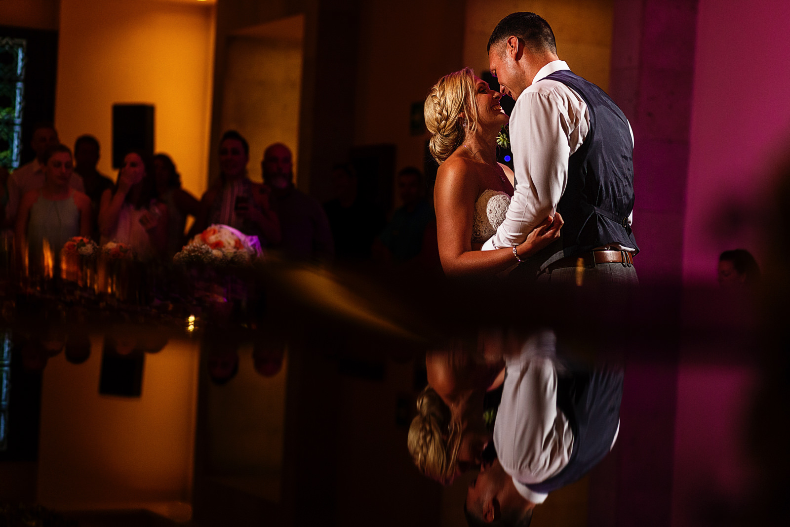 Groom and bride smiling during their first dance